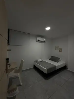 a bedroom with a bed and a table and a chair at Hotel La Estrella de David Cartagena in Cartagena de Indias