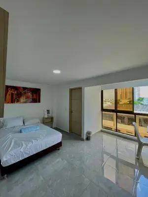 a bedroom with a bed and a large window at Hotel La Estrella de David Cartagena in Cartagena de Indias