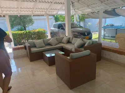 a living room with a couch and chairs and a car at Casa Luna in Santa Veronica