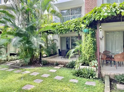 a house with a garden with a table and chairs at Walled City apt- Rooftop Pool & Private Garden in Cartagena de Indias