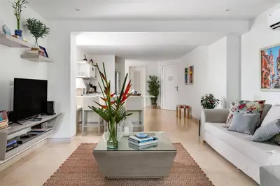 a living room with a white couch and a table at Walled City apt- Rooftop Pool & Private Garden in Cartagena de Indias