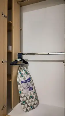 a tie hanging on a shelf in a closet at Precioso Apartamento Duplex en gran ubicación in Barranquilla