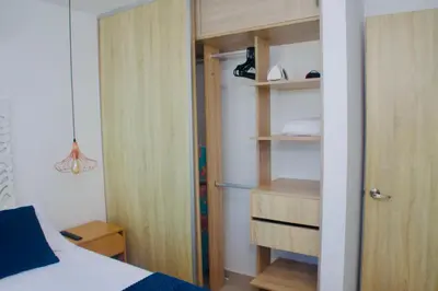a bedroom with a bed and a book shelf at Melodias de Verano in Cartagena de Indias