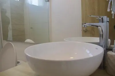 a bathroom with a white sink and a mirror at Melodias de Verano in Cartagena de Indias
