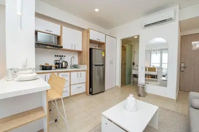 a kitchen and living room with white cabinets at CB1135 | Suite balcón privado y vista relajante in Cartagena de Indias