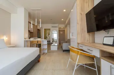 a hotel room with a bed and a kitchen at CB1135 | Suite balcón privado y vista relajante in Cartagena de Indias