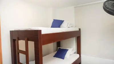 a bunk bed in a room with blue pillows at Hermoso Apartamento Frente al Mar 2 Habitaciones B12B in Coveñas