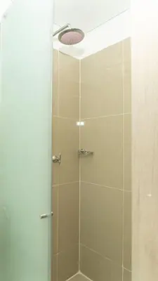 a shower with a glass door with a shower head at CB 1002 | Suite moderna con vista al mar infinita in Cartagena de Indias