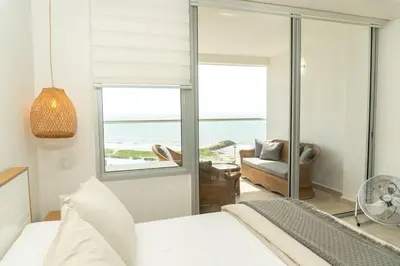 a bedroom with a bed and a view of the ocean at CB 1002 | Suite moderna con vista al mar infinita in Cartagena de Indias