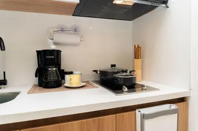 a kitchen counter with two pots and a coffee maker at CB1004 Nueva Suite Frente al Mar - 2min Aeropuerto in Cartagena de Indias