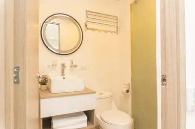 a bathroom with a white toilet and a mirror at Comoda Suite Vista al lago-Amanecer hermoso CB1130 in Cartagena de Indias