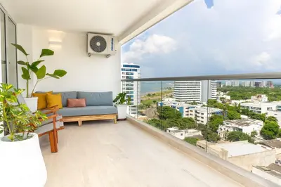 a balcony with a couch and a view of the city at Comoda Suite Vista al lago-Amanecer hermoso CB1130 in Cartagena de Indias