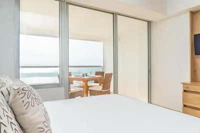 a bedroom with a bed and a view of the ocean at CB1204 | Suite minimalista frente al mar y atardeceres in Cartagena de Indias