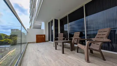 a balcony with chairs and tables on a building at Piscinas con vista increible, bar, música y playa in Cartagena de Indias
