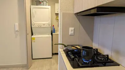 a kitchen with a stove and a refrigerator at Piscinas con vista increible, bar, música y playa in Cartagena de Indias