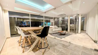 a dining room with a wooden table and chairs at Piscinas con vista increible, bar, música y playa in Cartagena de Indias