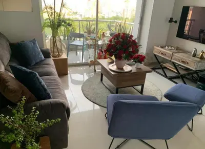 a living room with a couch and a table at Yuyos apartamentos acogedores in Barranquilla
