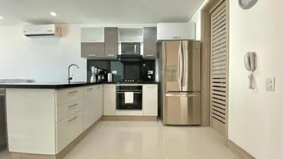 a kitchen with white cabinets and stainless steel appliances at Apartamento de una habitacion Palmetto Sunset 1703 in Cartagena de Indias