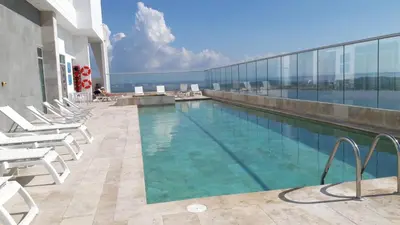 a swimming pool on the roof of a building at Apartamento de una habitacion Palmetto Sunset 1703 in Cartagena de Indias