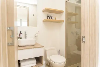 a bathroom with a toilet and a sink and a shower at Suite esquina con balcón y vista 180° al mar CB1429 in Cartagena de Indias