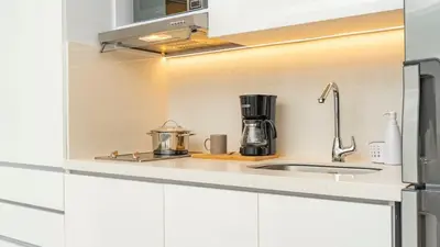 a kitchen with white cabinets and a sink at Suite esquina con balcón y vista 180° al mar CB1429 in Cartagena de Indias