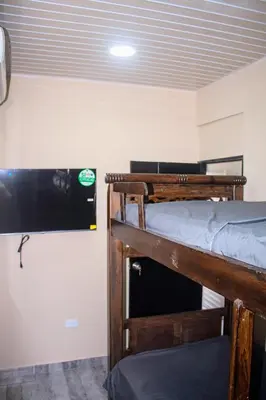 a bedroom with two bunk beds and a tv at Charles gomez in Cartagena de Indias