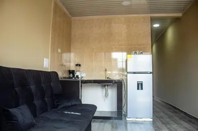 a living room with a couch and a refrigerator at Charles gomez in Cartagena de Indias