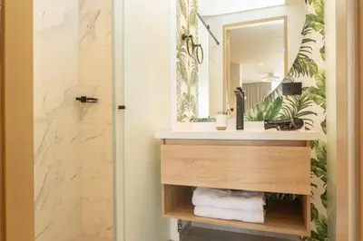a bathroom with a sink and a mirror at CB1526 | Suite tropical piso 15 frente al mar in Cartagena de Indias