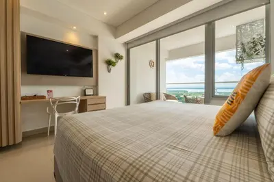a bedroom with a large bed with a large window at CB1531 | Confort premium: cama King y balcón in Cartagena de Indias