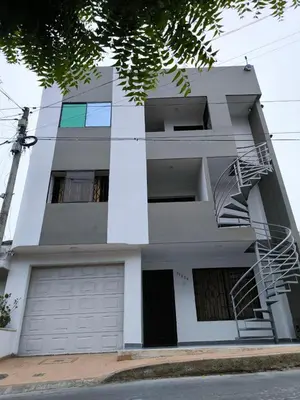 a white apartment building with a fire escape at Apartaestudios la terraza 1 in Sincelejo