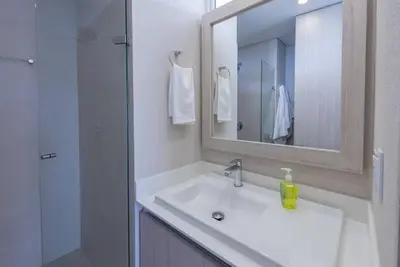 a bathroom with a sink and a shower with a mirror at 2BD Next to Beach W Pvt Jacuzzi Martinique 74 in Cartagena de Indias