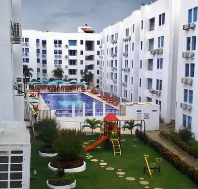 a large apartment complex with a pool and a playground at Caribe campestre coveñas in Coveñas
