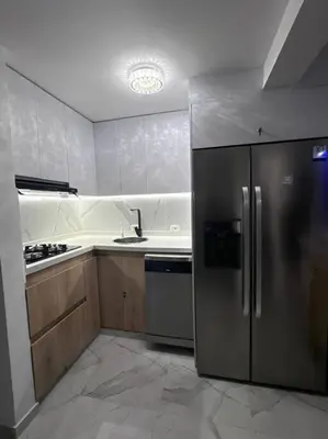 a kitchen with a stainless steel refrigerator and a sink at hermoso apto de lujo al norte alypao Deluxe in Barranquilla