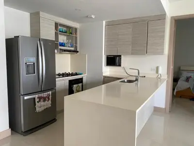 a kitchen with a stainless steel refrigerator and a counter at Apartamento en la playa mas tranquila de Cartagena in Cartagena de Indias