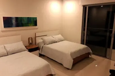 a bedroom with two beds and a window at Apartamento en la playa mas tranquila de Cartagena in Cartagena de Indias