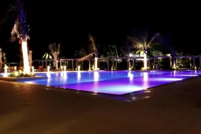 a large pool with blue lights at night at Apartamento en la playa mas tranquila de Cartagena in Cartagena de Indias
