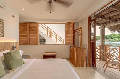 a bedroom with a bed and a large window at Islawa Soy Local - Isla Privada in Baru