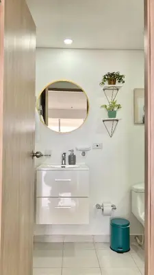 a bathroom with a sink and a mirror at CB726 | Suite moderna frente al mar con balcón y cocina con isla in Cartagena de Indias