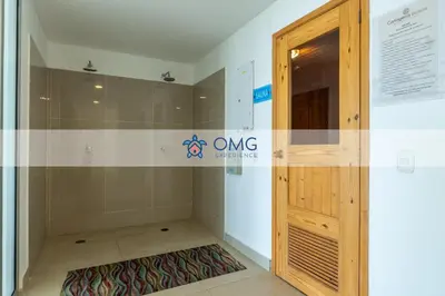 a shower with a wooden door in a room at Suite frente al mar + piscina + balcón privado 727 in Cartagena de Indias