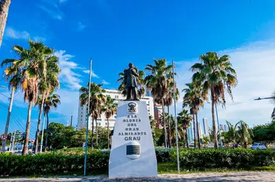 a statue in front of a building with palm trees at Dizztravel Apart Murano Centro Exclusivo apto 2701 in Cartagena de Indias