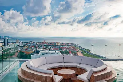 a room with a couch and a view of the city at Dizztravel Apart Murano Centro Exclusivo apto 2701 in Cartagena de Indias