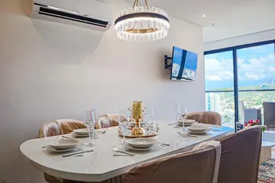 a dining room with a table and chairs and a chandelier at Dizztravel Apart Murano Centro Exclusivo apto 2701 in Cartagena de Indias