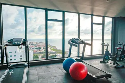 a gym with a view of the ocean in a building at Dizztravel Apart Murano Centro Exclusivo apto 2701 in Cartagena de Indias