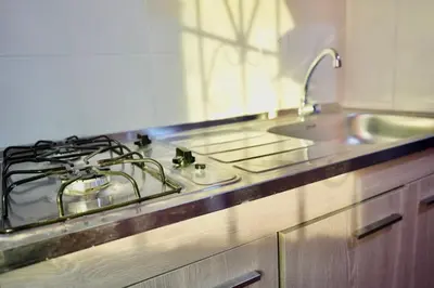 a kitchen with a stove top and a sink at Apartaestudios la terraza 2 in Sincelejo