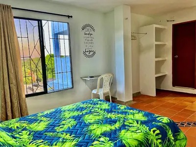 a bedroom with a bed and a window at Apartaestudios la terraza 3 in Sincelejo