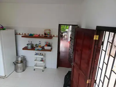 a room with a kitchen with a door and a refrigerator at campestre, naturaleza, confort, familiar in Turbaco