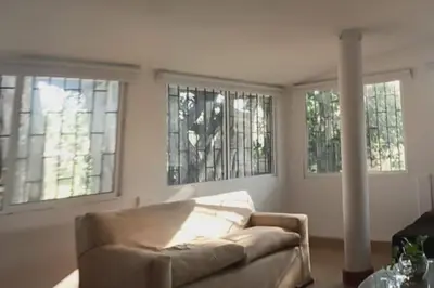 a living room with a couch and three windows at campestre, naturaleza, confort, familiar in Turbaco