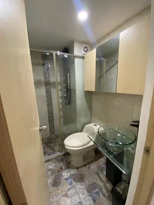 a bathroom with a toilet and a glass sink at Apto para vacaciones en familia in Cartagena de Indias