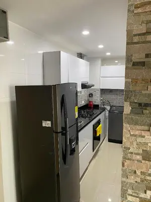 a kitchen with a black refrigerator and a stove at Apto para vacaciones en familia in Cartagena de Indias