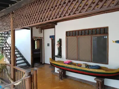 a boat on the wall of a room with a staircase at Cabaña Azores, Barú, Cartagena in Baru
